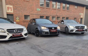 Image showing three vehicles parked in the parking lot after being repaired by racers paint and panel