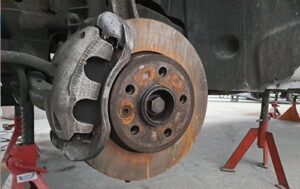 Image shows rusted wheel hub, rotor and Original Callipers prior to customisation at Racers Paint and Panel