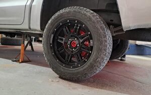 Image shows the back wheel with high gloss black rim respray and brake calliper Customisation at Racers Paint and Panel