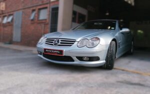 This picture shows a Mercedes Benz after having a bumper repair parked in the entrance to the Racers Paint and Panel workshop