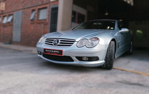 This picture shows a Mercedes Benz after having a bumper repair parked in the entrance to the Racers Paint and Panel workshop
