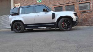 Land Rover Defender after auto body repair at Racers Paint and Panel with custom callipers featured on the Contact us page of the website
