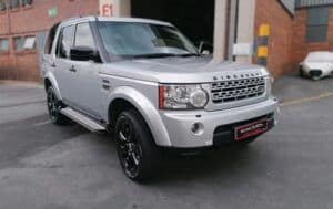 Racers Customs Landrover Discovery with custom brake callipers and mag rims parked outside racers paint and panel