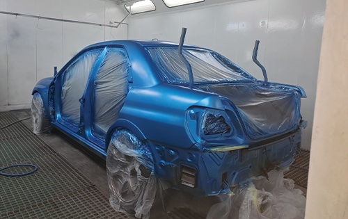Image shows a Subaru inside the booth for car respray at racers paint and panel in jophannesburg