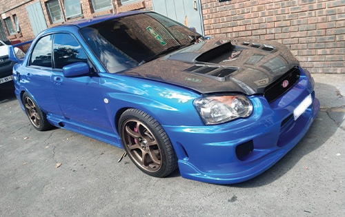 Image shows a Subaru parked outside racers after full car respray - Racers paint and panel in jophannesburg