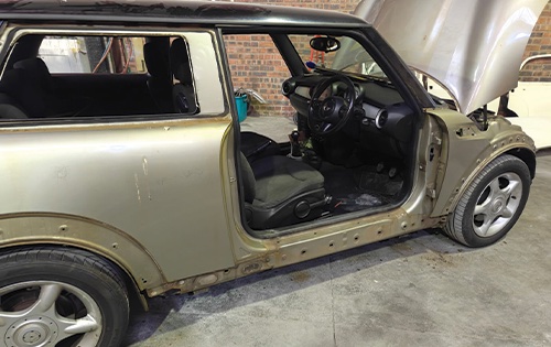 Image shows a mini cooper being diassembled ahead of a full car respray at racers paint and panel in johannesburg