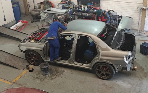 Image shows a subaru being stripped ahead of a full car respray at racers paint and panel in johanneburg