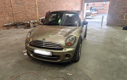 image shows a mini cooper at racers paint and panel ahead of a full car respray