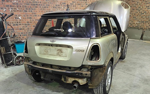 image shows a mini cooper beffore a full respray at racers paint and panel