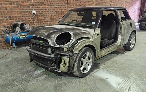 image shows a mini cooper fully disassembled and ready full respray at racers paint and panel in johannesburg